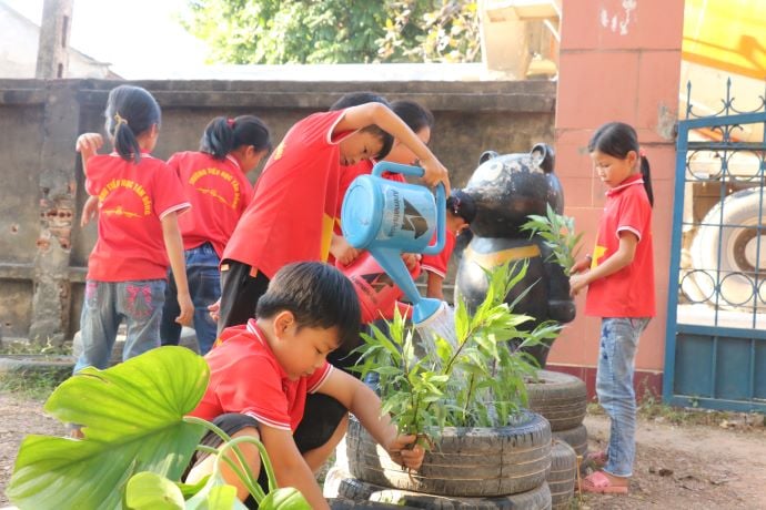 school kids watering plants