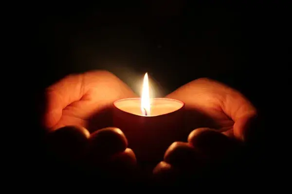 CANDLE IN HANDS